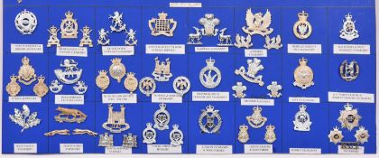 24 mostly Yeomanry anodised cap badges, some accompanied by their matching pairs of collar badges,