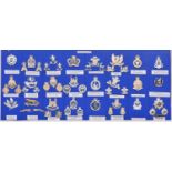 24 mostly Yeomanry anodised cap badges, some accompanied by their matching pairs of collar badges,