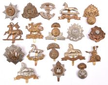 18 Infantry OR’s cap badges, mostly WWII pattern but including pre 1935 Northumberland Fusiliers,