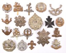 19 Infantry OR’s cap badges, mostly WWII pattern but including pre 1920 Loyal North Lancashire (weak