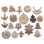 19 Infantry OR’s cap badges, mostly WWII pattern but including pre 1920 Loyal North Lancashire (weak