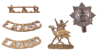 A cast brass badge of the Sudan Defence Force, with screw fitting; cast brass cap badge and pair