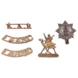 A cast brass badge of the Sudan Defence Force, with screw fitting; cast brass cap badge and pair