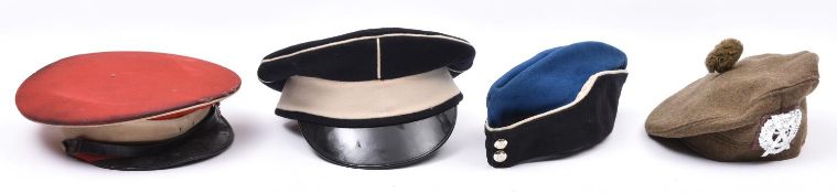An Officer’s peaked cap of the Yorkshire Hussars, c 1906, scarlet with white trim (badge not