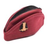 An OR’s crimson tent cap of the 11th Hussars, black crown and backing to regimental cap badge. GC £