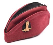 An OR’s crimson tent cap of the 11th Hussars, black crown and backing to regimental cap badge. GC £