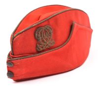 A scarce Victorian Officer’s scarlet field cap of the 7th Hussars, gilt bullion trim and