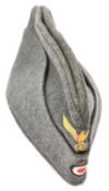 A Third Reich Army field grey side cap, with separate woven yellow eagle and cockade, the lining