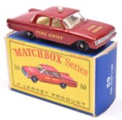 A Matchbox Series Ford Fairlane Fire Chief car (59b). In dark red with black plastic wheels.