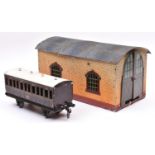 A Bing Gauge One single road engine shed in brick effect, finished in cream and brown with a blue-