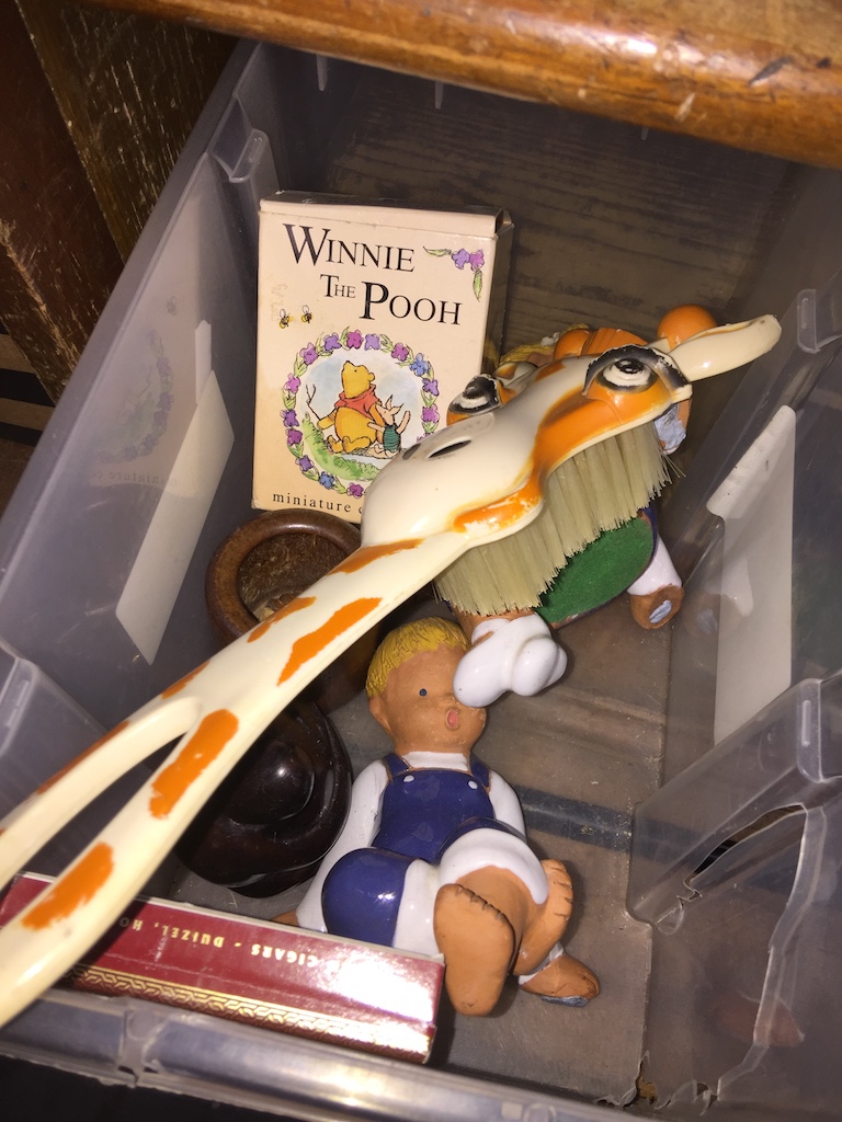 A box of small figures, including Winnie the Pooh.