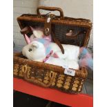 A wicker hamper basket with a pair of unicorn slippers