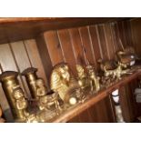 A shelf of mixed brassware