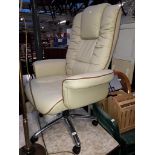 A cream leather adjustable swivel office chair