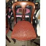 A pair of Victorian mahogany chairs with castors