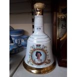 A Bells commemorative porcelain decanter (has been opened but still has contents)