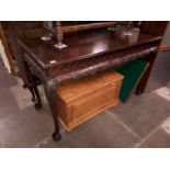 A reproduction George II style mahogany pier table with scroll frieze above acanthus and shell