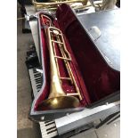 A cased brass horn instrument