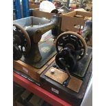 Two hand cranked Singer sewing machines