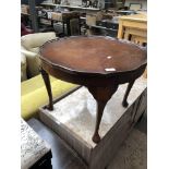 A round occasional table with pie crust edge