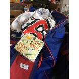 A bag of mainly American sports wear including baseball