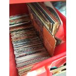 A box of vinyl records comprising approx. 25 LPs and over 100 45s circa 1960s - 1990s.