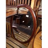 An inlaid mahogany oval mirror