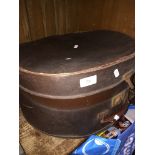 A circular leather hat box.