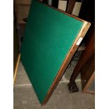 A green baize card table with sprung legs.