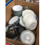 A box of pottery, dishes and plates.