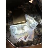 A tin of coins and bank notes