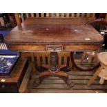 A Regency mahogany flip top pedestal tea table with large claw feet and brass castors