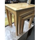 A modern light wood nest of tables