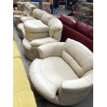 A cream leather 2 piece suite and pouffe