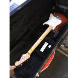 A Jim Deacon Strat style electric guitar, sunburst finish, hard case.