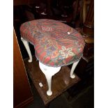 A kidney shaped dressing table stool