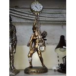 A large gilt figurine clock with swing pendulum