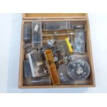 A wooden case of screws and bits