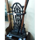 A cast iron stick stand and two walking sticks