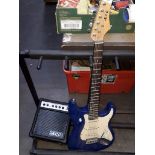 A KCC Strat style blue electric guitar and mini amp.