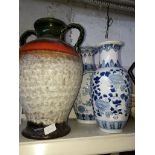 A West German twin handled vase and two blue and white eastern vases