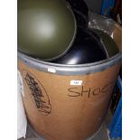 A drum full of military style helmets