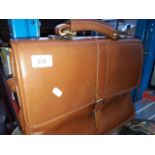 A tan leather messenger case