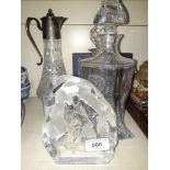 Three decanters, a claret jug, and a sculpted glass golf figure