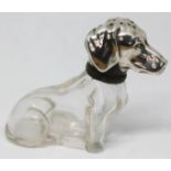 A novelty glass pepper pot formed as a seated dog with silver plated head, height 6cm.