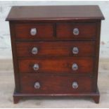 A Victorian mahogany 'apprentice' chest of drawers, height 39cm.