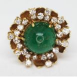 An emerald and diamond cocktail ring, the central cabochon cut emerald approx. 5mm x 5mm x 7mm,