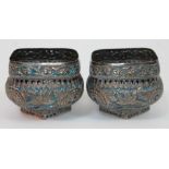 A pair of eastern silver and enamel sugar bowls decorated with flowers, unmarked, height 8.5cm,