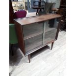 A mid 20th century century afromosia teak bookcase with sliding glass doors designed by Richard