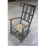 A Victorian bobbin turned rush seated rocking chair.